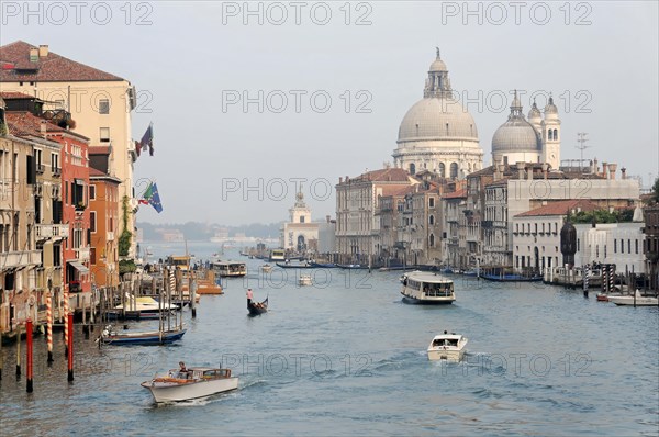 Grand Canal, behind the church of Santa Maria della Saluti, A lively scene on the Grand Canal in Venice with a view of the Doge's Palace, Venice, Veneto, Italy, Europe