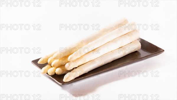 White asparagus spears served on a dark plate, AI generated, AI generated