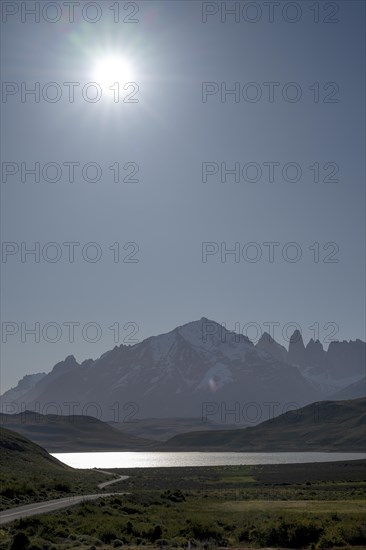 Lago Pehoe, mountain range of the Andes, backlight, sun, Torres del Paine National Park, Parque Nacional Torres del Paine, Cordillera del Paine, towers of the blue sky, Region de Magallanes y de la Antartica Chilena, Ultima Esperanza province, UNESCO biosphere reserve, Patagonia, end of the world, Chile, South America