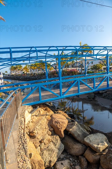 A beautiful blue bridge in the port of the touristic coastal town Mogan in the south of Gran Canaria. Spain
