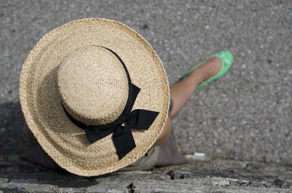 Woman with Straw Hat and Green Shoes and Leaning on the Wall