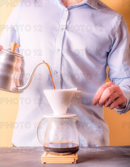 Person concentrating on manually brewing coffee with a pour-over filter setup, Vertical aspect ratio, AI generated