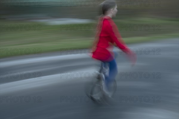 Girl, 10 years old, riding a unicycle, motion blur, Mecklenburg-Vorpommern, Germany, Europe