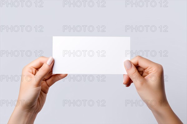 Woman's hand holding up white empty paper sign. KI generiert, generiert, AI generated
