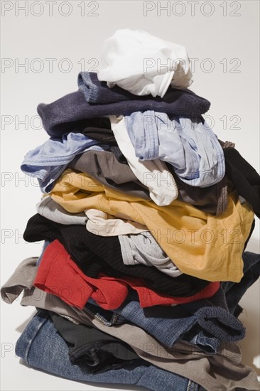 Close-up of pile of dirty clothes that includes blue jeans, underwear and t-shirts on white background, Studio Composition, Quebec, Canada, North America