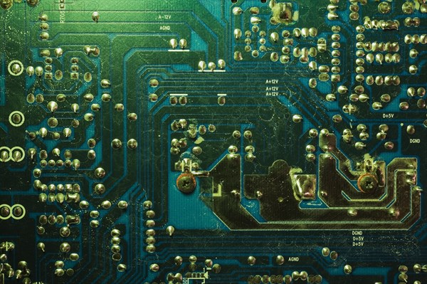 Close-up of green lighted electronic computer circuit board with silver solder points and lines, Studio Composition, Quebec, Canada, North America
