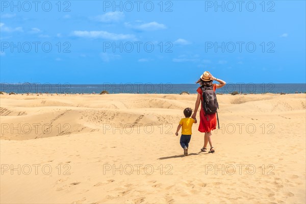 Mother and child on summer vacation in the dunes of Maspalomas, Gran Canaria, Canary Islands