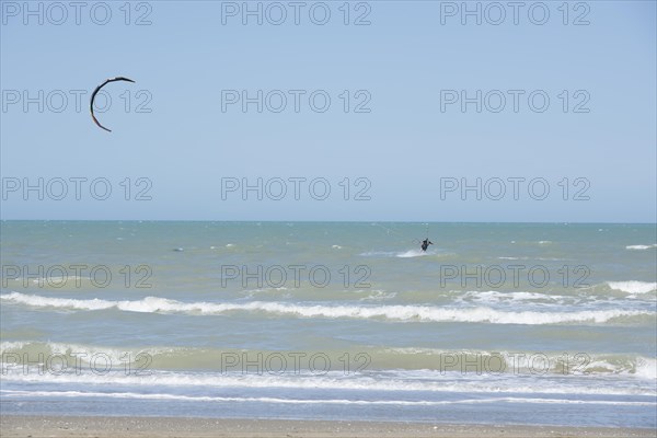 Kitesurfing Cutting Through the Waves in a Sunny Summer Day in Emilia Romagna, Rimini, Italy, Europe