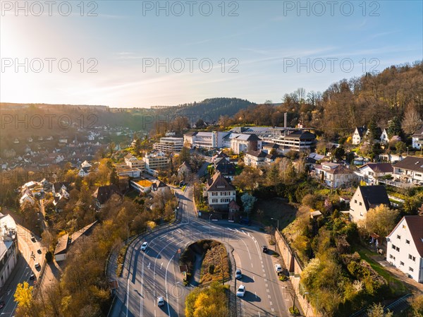 The evening sun bathes the town and the surrounding hills in warm light, Calw, Black Forest, Germany, Europe
