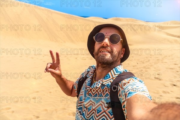 Selfie of a tourist enjoying in the dunes of Maspalomas, Gran Canaria, Canary Islands