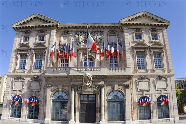 Old Town Hall, Hotel de Ville, at the Old Harbour, Marseille, Impressive town hall building decorated with flags under a blue sky, Marseille, Departement Bouches-du-Rhone, Region Provence-Alpes-Cote d'Azur, France, Europe