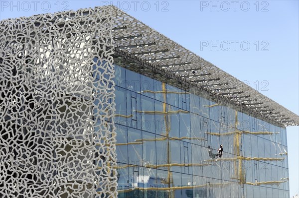 Marseille harbour, window cleaner working on the extraordinary facade of a modern building, Marseille, Departement Bouches-du-Rhone, Provence-Alpes-Cote d'Azur region, France, Europe