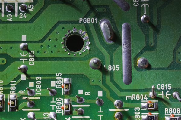 Close-up of green electronic computer circuit board with printed white numbers and letters and silver solder points, Studio Composition, Quebec, Canada, North America