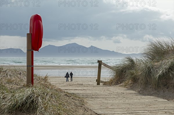 Life buoy, beach access, people, mountains, LLanddwyn Bay, Newborough, Isle of Anglesey, Wales, Great Britain
