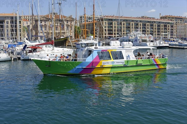 Marseille harbour, A colourful excursion boat in the harbour with city background, Marseille, Departement Bouches-du-Rhone, Region Provence-Alpes-Cote d'Azur, France, Europe