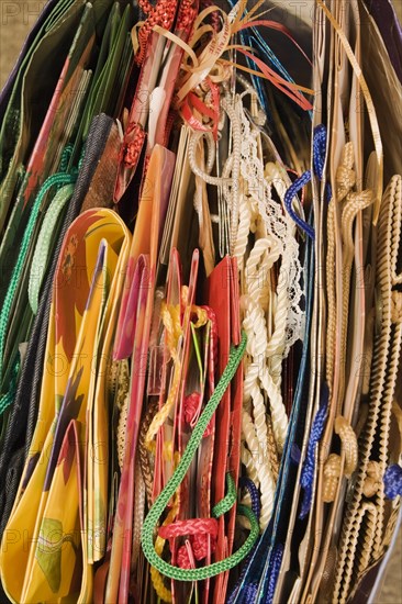 Top view and close-up of red, yellow, green, blue, folded paper gift bags with rope handles, Studio Composition, Quebec, Canada, North America