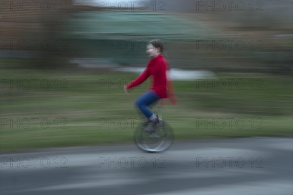 Girl, 10 years old, riding a unicycle, motion blur, Mecklenburg-Vorpommern, Germany, Europe