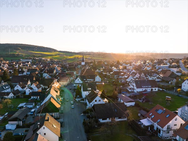 Evening atmosphere in a village with a view of residential areas and church tower, Calw, Black Forest, Germany, Europe