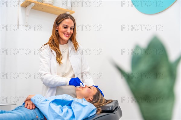 Woman relaxed on stretcher of a beautician clinic after treatment with hyaluronic acid