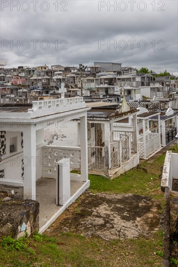 Famous cemetery, manyFamous cemetery, many mausoleums or large tombs decorated with tiles, often in black and white. Densely built buildings under a dramatic cloud cover Cimetiere de Morne-a-l'eau, Grand Terre, Guadeloupe, Caribbean Mausoleum or large tombs decorated with tiles, Caribbean, North America