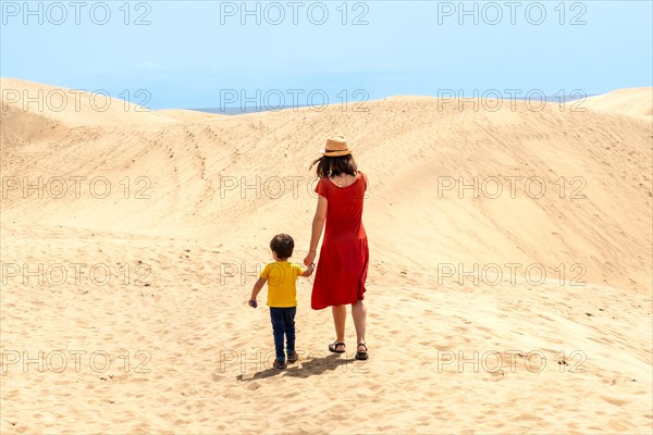 Mother and son tourists exploring the dunes of Maspalomas, Gran Canaria, Canary Islands