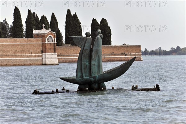 Bronze monument to Dante, 2007, standing in a barge, Virgil points to the cemetery island of San Michele, Russian sculptor George Frangulyan, Venice Lagoon, San Michele Island, A bronze statue appears to rise from a murky body of water next to an island cemetery wall, Venice, Veneto, Italy, EuropaVenice, Europe