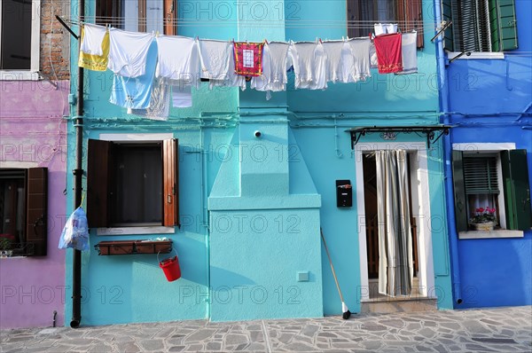 Colourful houses, Burano, Burano Island, Traditional everyday life with laundry drying on a colourful house facade, Burano, Venice, Veneto, Italy, Europe