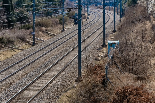 Train tracks running through industrial area on outskirts of small town in South Korea