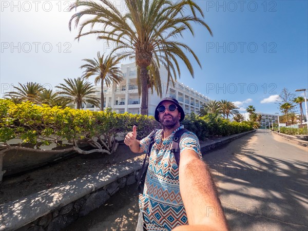 A tourist walking towards the dunes of Maspalomas, Gran Canaria, Canary Islands