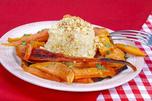 South German cuisine, butternut squash, butternut squash, baked squash with goat's cheese, cheese in a nut crust, nut coating, vegetables cut on a plate, fork, oven vegetables, pumpkin, fruit vegetables, fruit, carrots, celery, healthy cooking, vegetarian, autumn cuisine, pumpkin dishes, food, studio, Germany, Europe