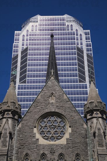 Old Christ Church Cathedral facade with rose window and modern architectural steel and blue tinted glass windows KPMG office tower in summer, Montreal, Quebec, Canada, North America