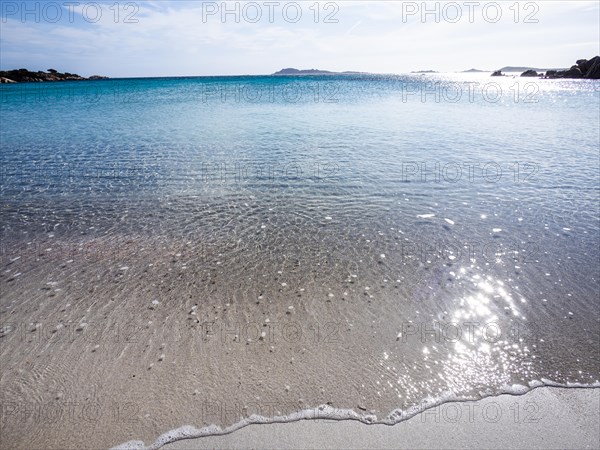 Waves reach the sandy beach, glittering sea, Capriccioli beach, Costa Smeralda, Sardinia, Italy, Europe