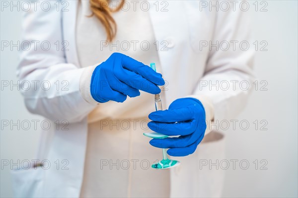 Part of and close-up of a female doctor holing a botox injection in an aesthetic clinic