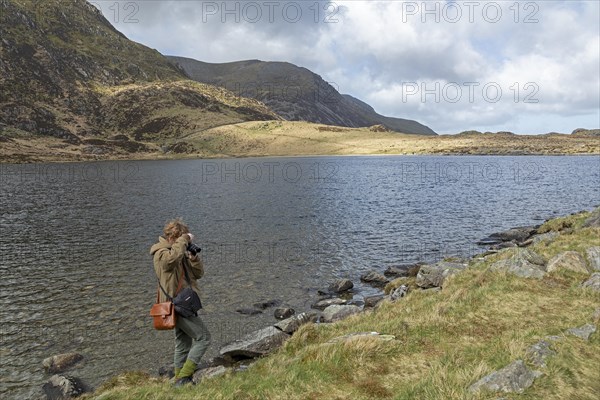 Woman photographed, Lake LLyn Idwal, Snowdonia National Park near Pont Pen-y-benglog, Bethesda, Bangor, Wales, Great Britain