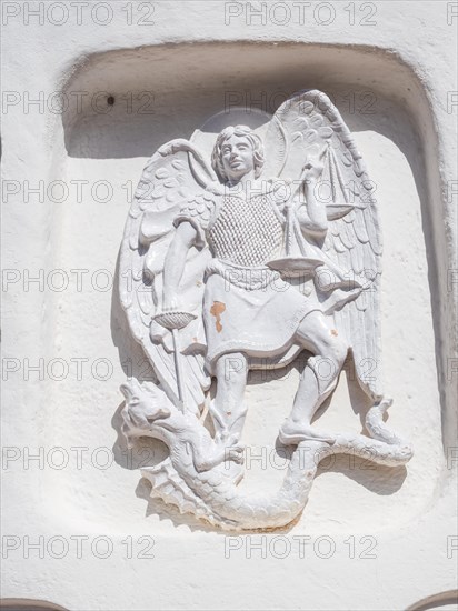 Stone sculpture, St George as dragon slayer, relief on the facade of the Stella Maris church, Porto Cervo, Costa Smeralda, Sardinia, Italy, Europe