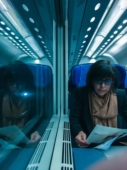 Woman Travel in a Train and Reading a Newspaper in Monaco. | MR:yes Maria-CH-02-05-2023