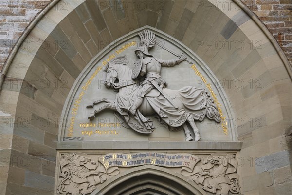 Eagle Gate, stone relief on the outer castle gate, knight figure on horse, armour, inscription, Hohenzollern Castle, ancestral castle of the Prussian royal and German imperial dynasty of Hohenzollern, summit castle, historic building by the Berlin architect Friedrich August Stueler, architecture, neo-Gothic, castle building, aristocratic residence, Bisingen, Zollernalbkreis, Baden-Wuerttemberg, Germany, Europe