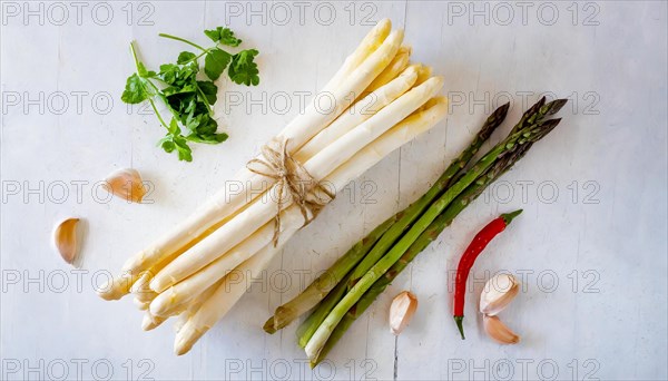 Fresh white and green asparagus on a rustic white background next to chilli and garlic, fresh white asparagus, KI generated, AI generated