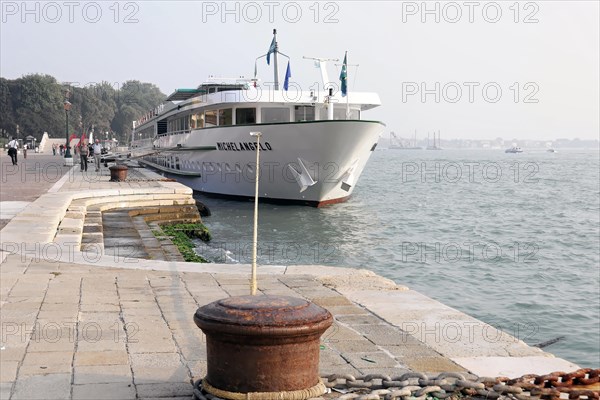 MICHELANSELO, A modern cruise ship lies on a quay while people walk by, Venice, Veneto, Italy, Europe