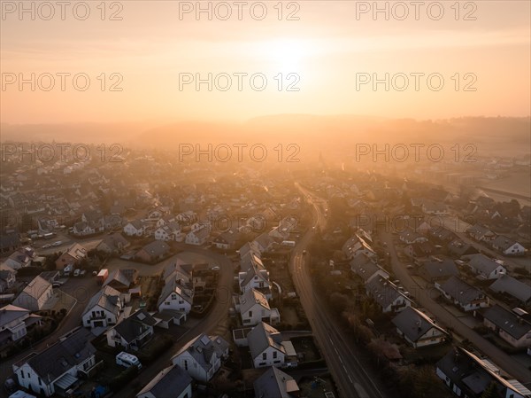 The morning sun illuminates the sleepy suburbs with a warm glow, Gechingen, Black Forest, Germany, Europe