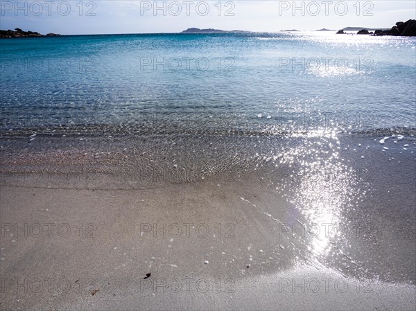 Waves reach the sandy beach, glittering sea, Capriccioli beach, Costa Smeralda, Sardinia, Italy, Europe