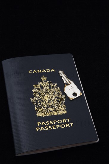Close-up of chrome key on top of Canadian passport on black background, Studio Composition, Quebec, Canada, North America