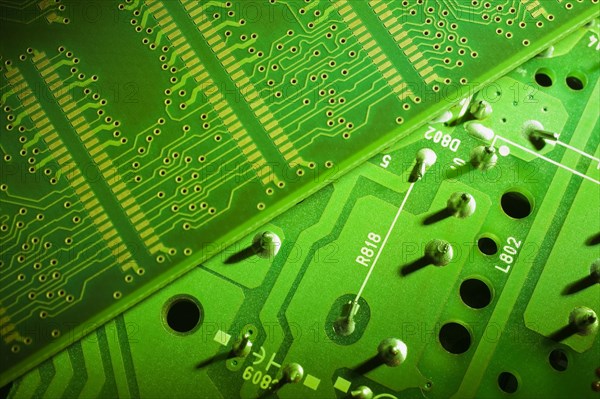 Close-up of fluorescent green lighted electronic computer circuit boards with silver solder points and lines, Studio Composition, Quebec, Canada, North America