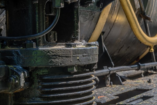 Close-up view of train's hydraulic machinery showcasing metallic textures and technical components, in South Korea