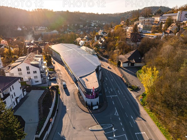 Aerial view of a shopping centre with parked cars in a residential area at sunset, Calw, Black Forest, Germany, Europe