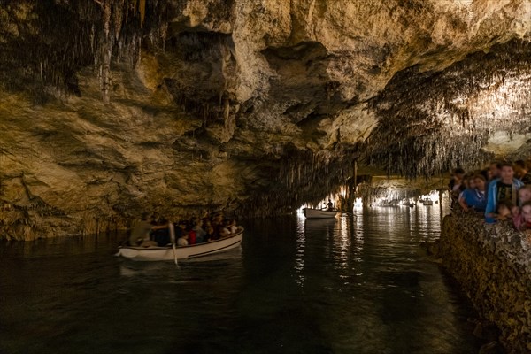 People in the boat on lake in amazing Drach Caves in Mallorca, Spain, Europe