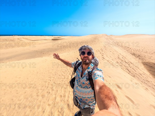 Selfie of a tourist with sunglasses enjoying in the dunes of Maspalomas, Gran Canaria, Canary Islands