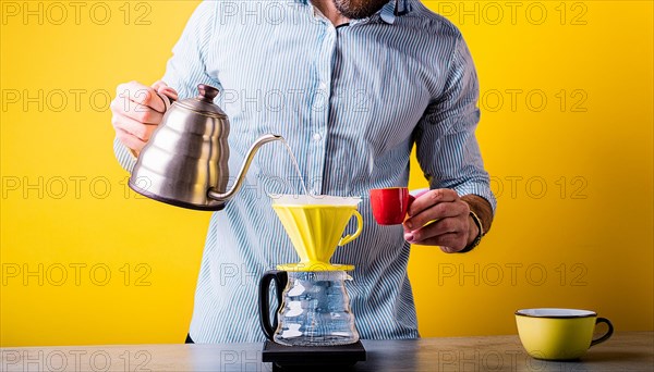 Man with kettle pouring water into a pour-over coffee maker against a vibrant yellow background, horizontal, AI generated