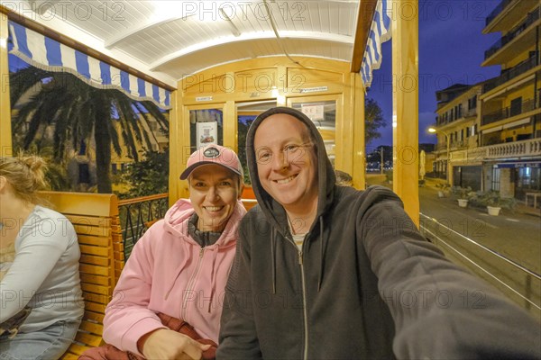 People sitting in the traditional tram in Soller, Mallorca, Spain, Europe