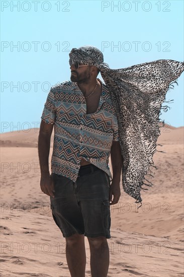 Portrait of tourist man with turban in summer in the dunes of Maspalomas, Gran Canaria, Canary Islands. Vintage style